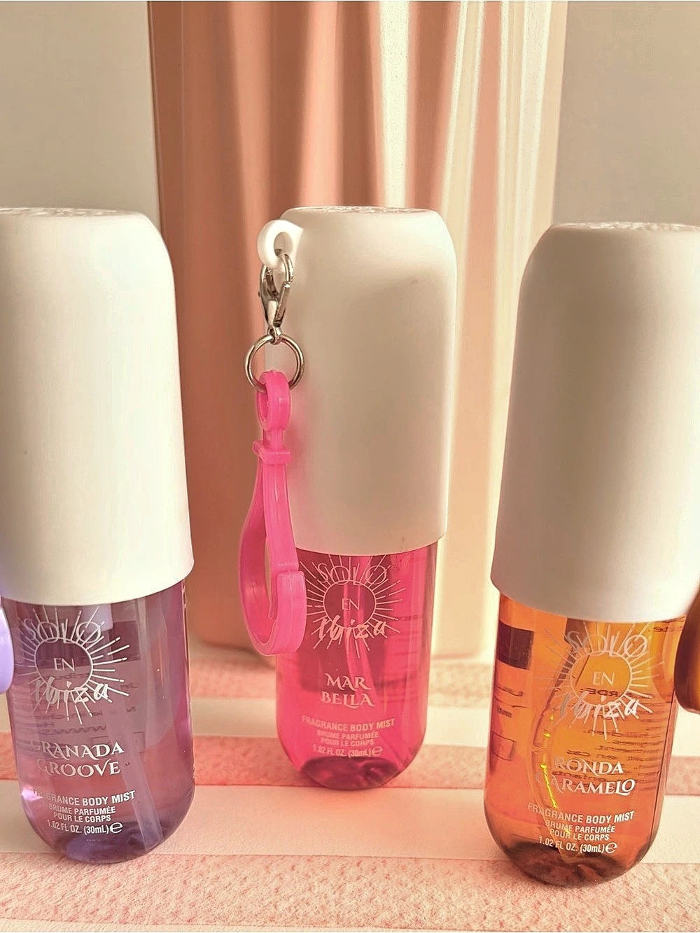 Trio body sprays, with accessory to hang on purse. Sents are vanilla, lavender,